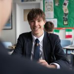 boy smiling in classroom