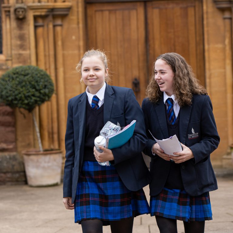 Two students walking outside the chapel