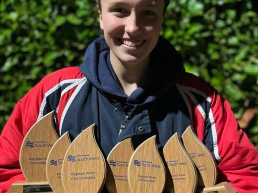 Chloe with her seven trophies after a phenomenal display at the Swim England South West Winter Regionals
