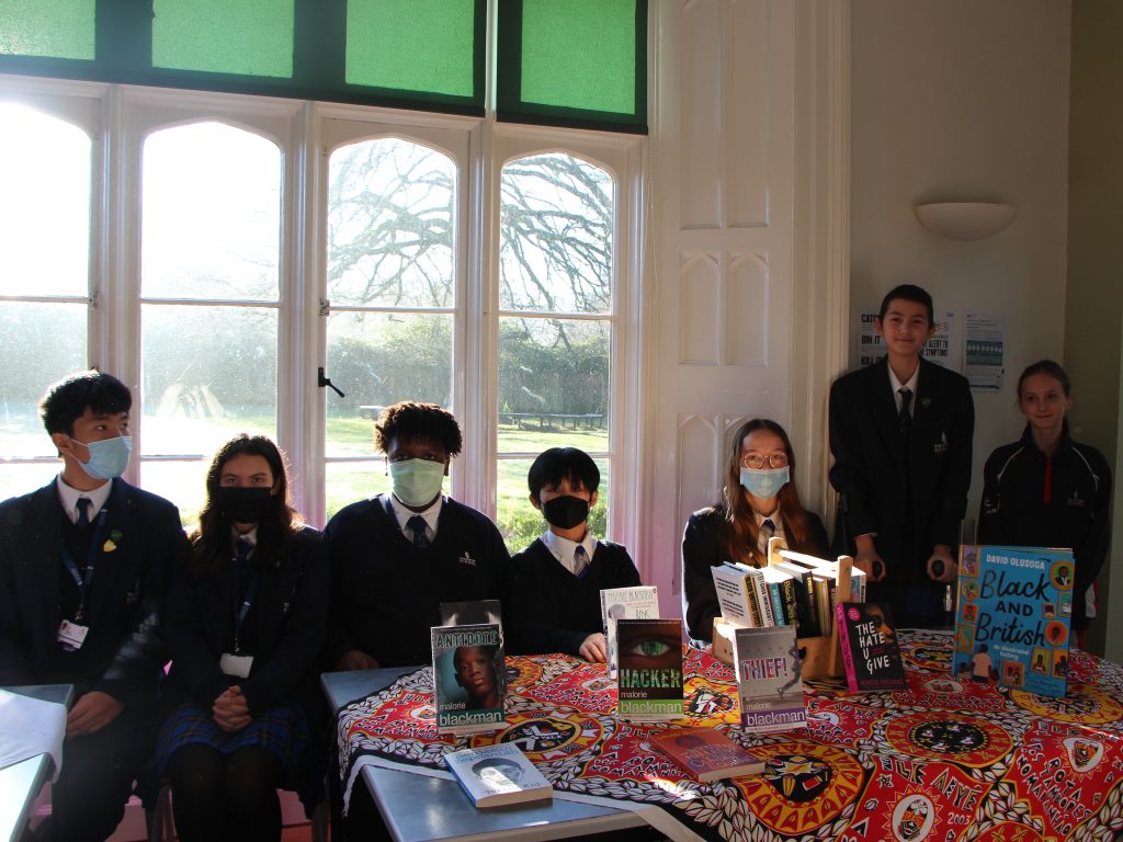 International school students sat at a table with books on the desk
