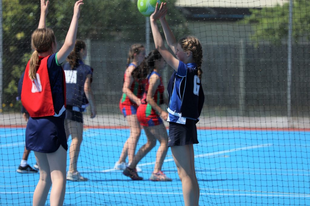 A pair of students competing for the netball