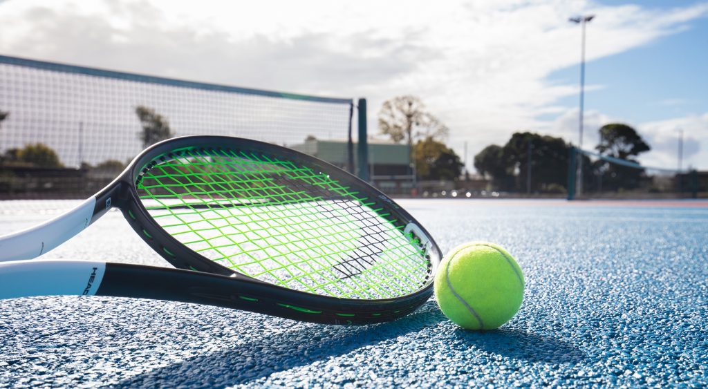 A picture of a tennis racket and ball