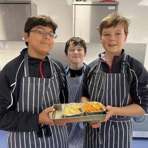 three pupils cooking