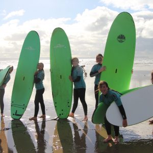 students surfing at the beach