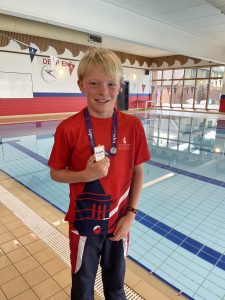 Bot with medal next to swimming pool
