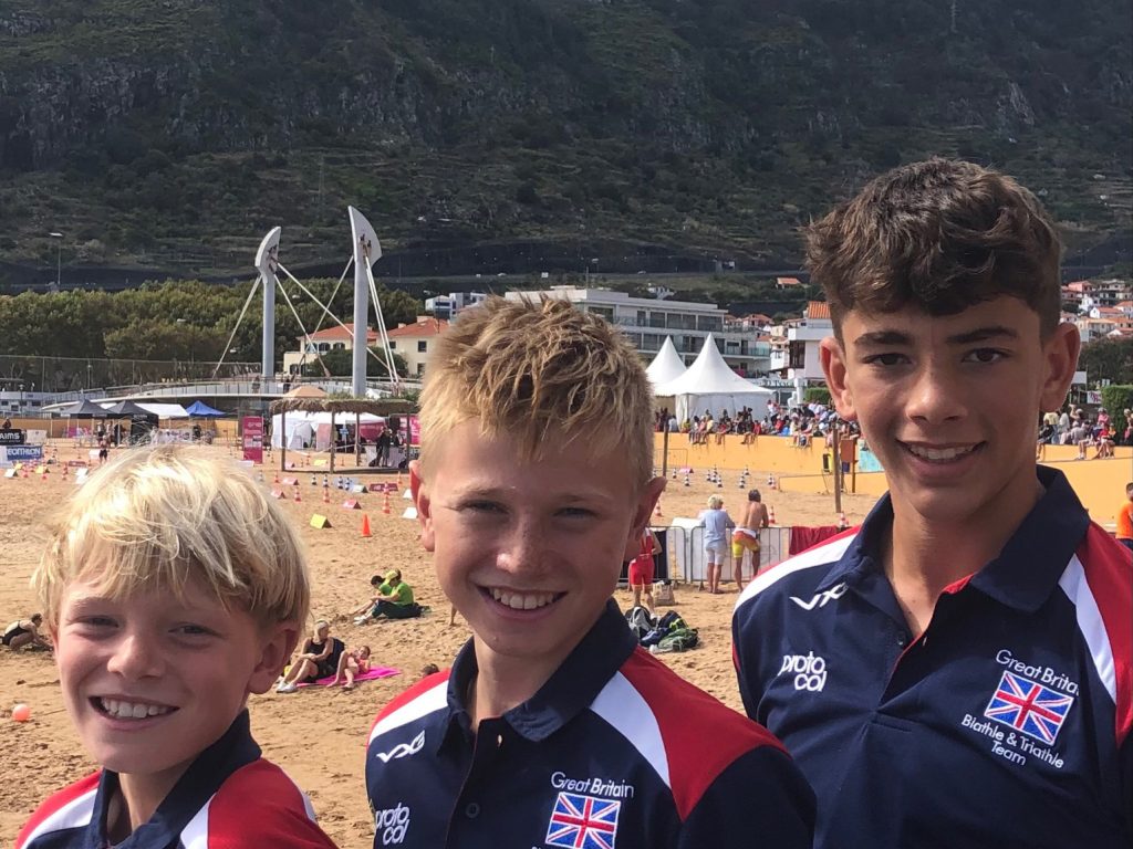 Three boys in GB sportswear standing on the beach